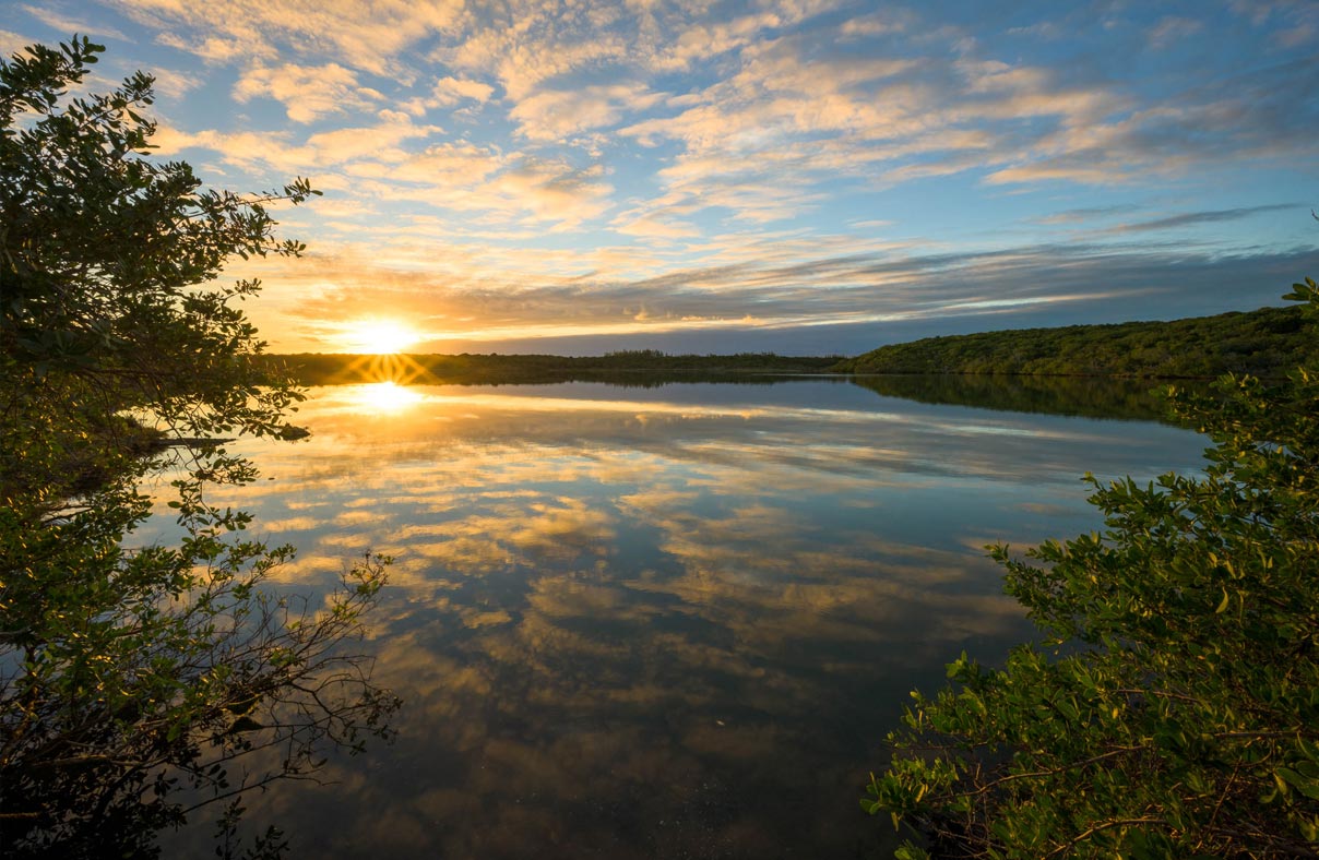 A meditation lake at sunset on the Jack's Bay land.
